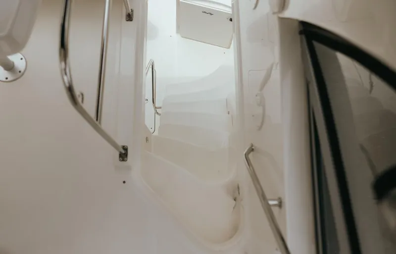 Slide: The Image of Staircase on 2010 Sea Ray 390 Sedan Bridge yacht, featuring sleek white design and metal railings. - 25