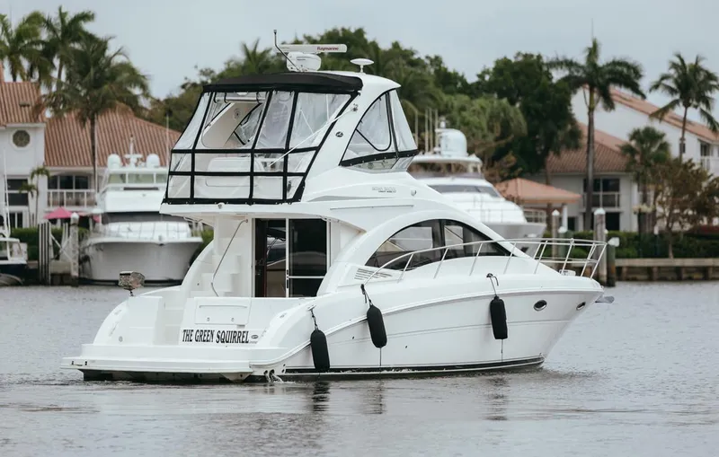 Slide: The Image of 2010 Sea Ray 390 Sedan Bridge yacht docked near waterfront homes. - 4