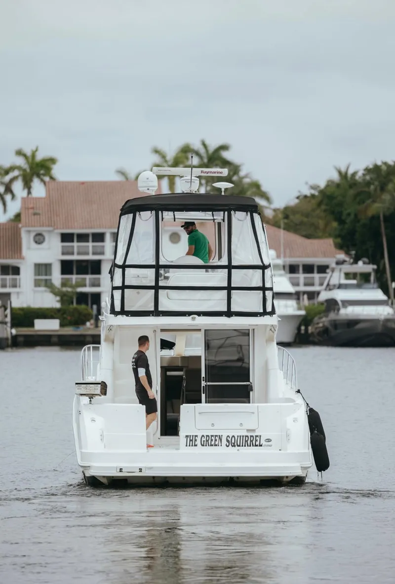 Slide: The Image of 2010 Sea Ray 390 Sedan Bridge yacht on water, named "The Green Squirrel." - 5