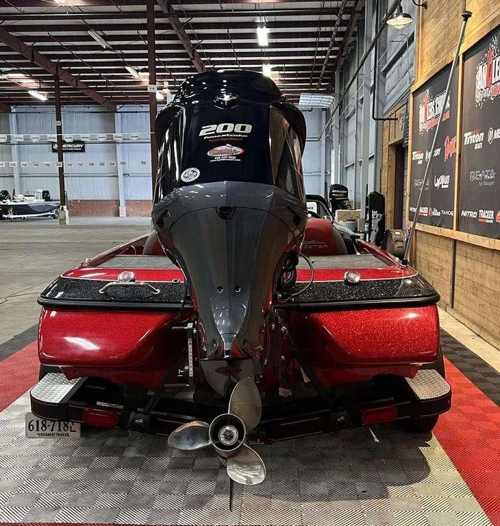 Slide: The Image of 2015 Skeeter ZX 200 boat in a showroom, showcasing its powerful engine. - 7