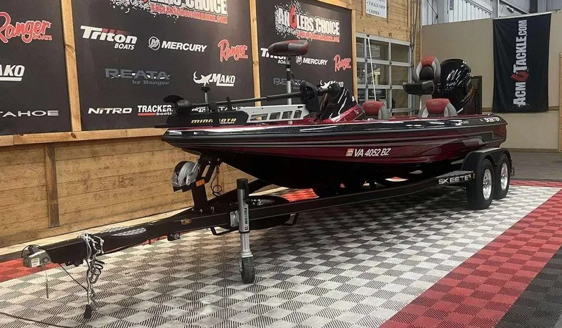 Slide: The Image of 2015 Skeeter ZX 200 bass boat on trailer in showroom with branded banners. - 8