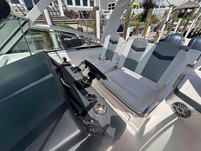 Slide: The Image of 2020 Chaparral 300 OSX boat interior with modern seating and steering console. - 10