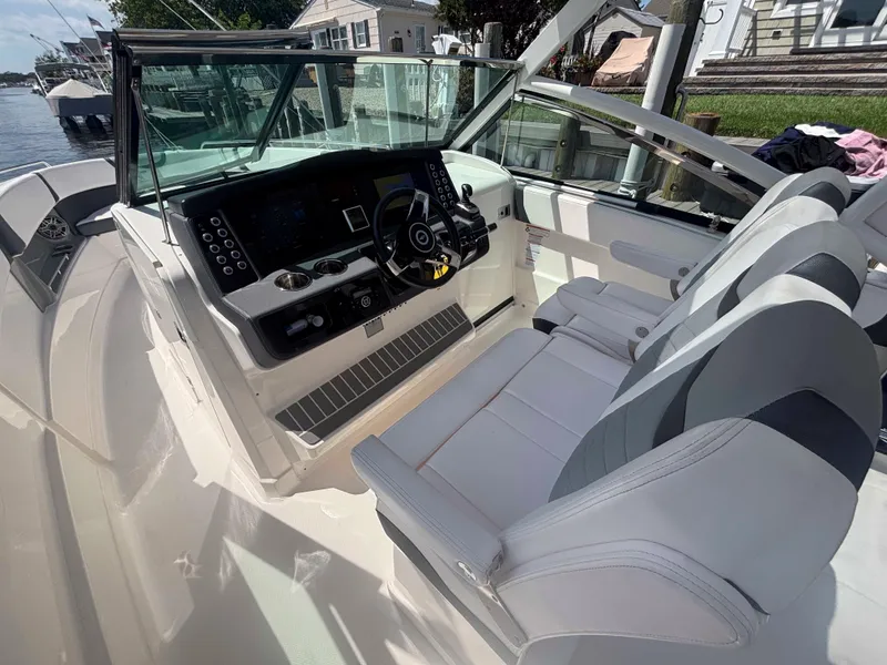 Slide: The Image of 2020 Chaparral 300 OSX boat cockpit with modern controls and seating. - 11