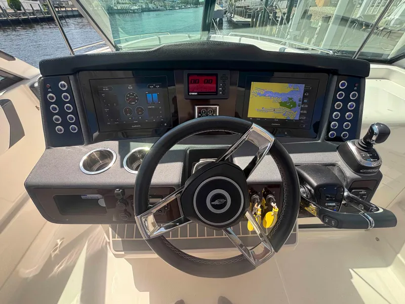 Slide: The Image of Cockpit of 2020 Chaparral 300 OSX boat with steering wheel and navigation displays. - 12