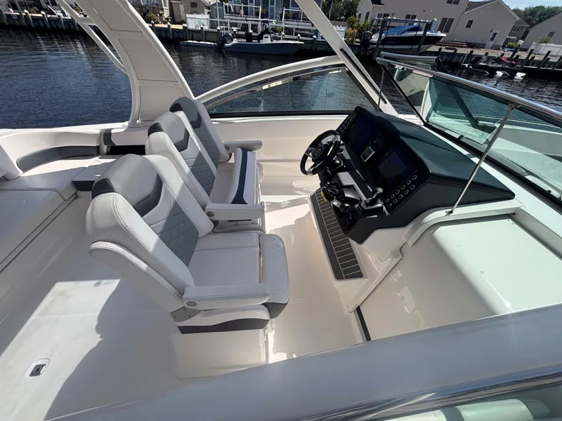 Slide: The Image of 2020 Chaparral 300 OSX boat interior with dual seats and modern dashboard. - 19