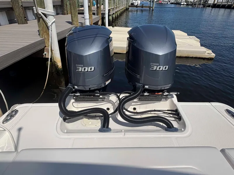 Slide: The Image of Twin Yamaha 300 engines on a 2020 Chaparral 300 OSX boat at a dock. - 24