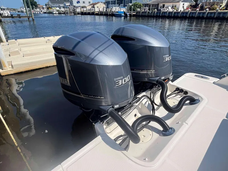 Slide: The Image of Twin Yamaha 300 outboard engines on a 2020 Chaparral 300 OSX boat docked by the water. - 25