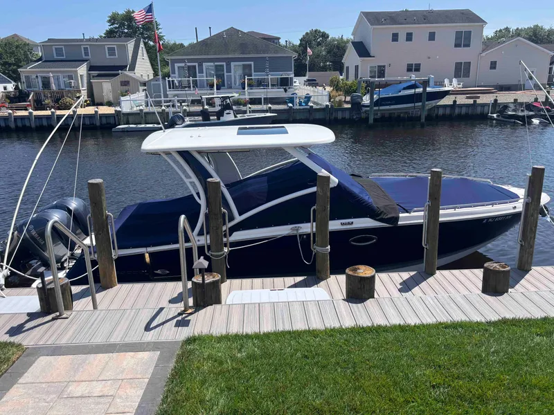 Slide: The Image of 2020 Chaparral 300 OSX boat docked by waterfront homes. - 3