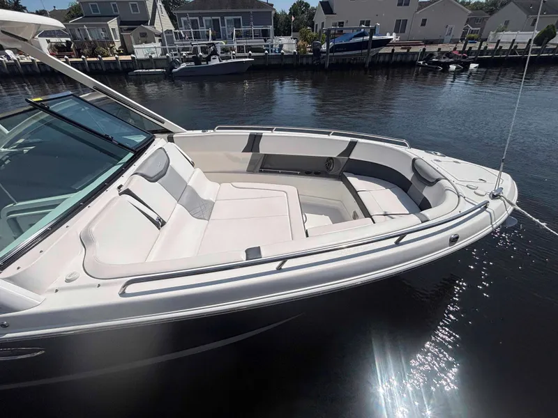 Slide: The Image of 2020 Chaparral 300 OSX boat docked, featuring spacious seating and sleek design. - 32