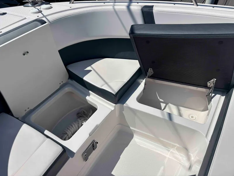 Slide: The Image of 2020 Chaparral 300 OSX boat interior with open storage compartments and seating. - 34