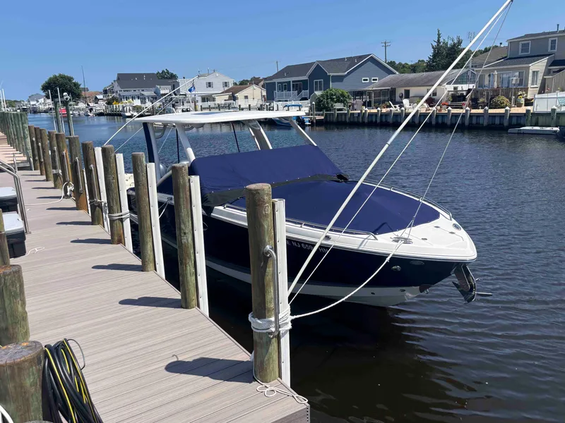 Slide: The Image of 2020 Chaparral 300 OSX boat docked in a residential canal setting. - 6