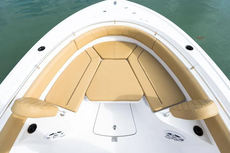 Slide: The Image of 2025 Sportsman Heritage 231 boat with tan cushioned seating in the bow area. - 10