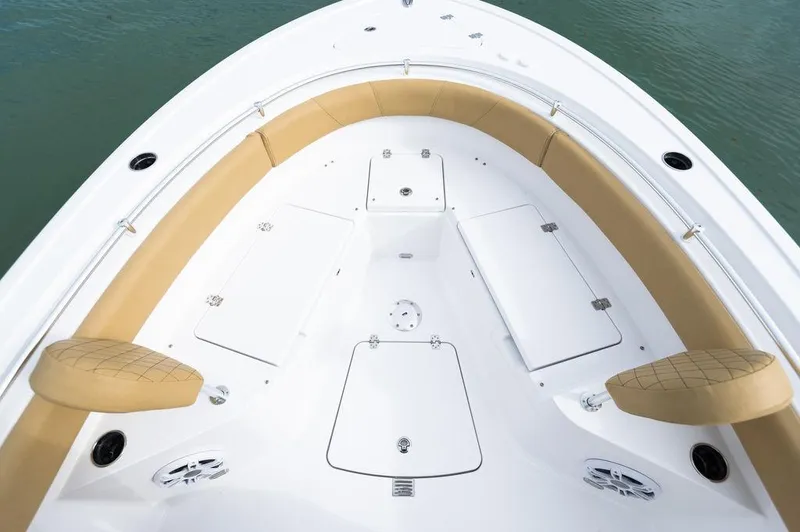 Slide: The Image of 2025 Sportsman Heritage 231 boat interior with tan seating and storage compartments. - 16