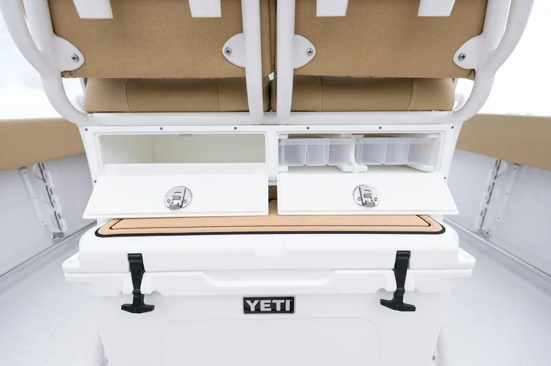 Slide: The Image of 2025 Sportsman Heritage 231 boat storage with YETI cooler and seating. - 19