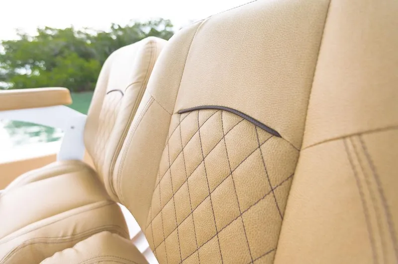 Slide: The Image of Luxurious tan leather seats on 2025 Sportsman Heritage 231 boat, featuring diamond stitching. - 22