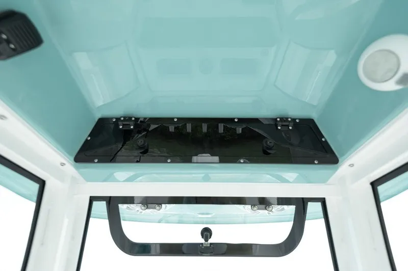 Slide: The Image of 2025 Sportsman Heritage 231 boat interior ceiling with storage compartment. - 24