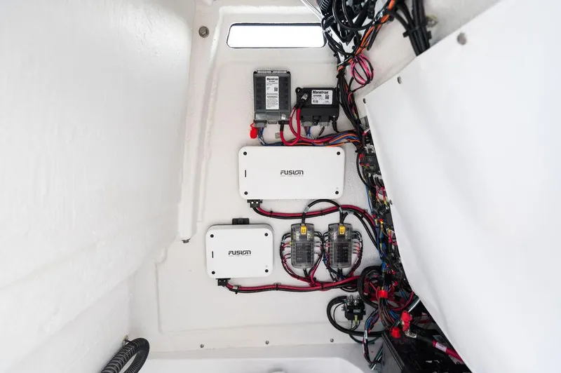 Slide: The Image of Interior wiring of 2025 Sportsman Heritage 231 boat, featuring Fusion electronics and organized cables. - 26