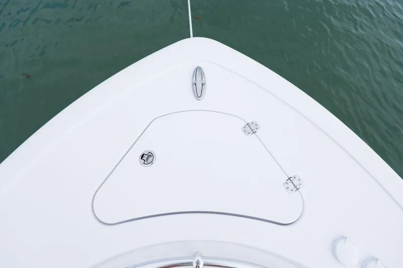 Slide: The Image of Bow of 2025 Sportsman Heritage 231 boat on water, featuring storage hatch. - 7