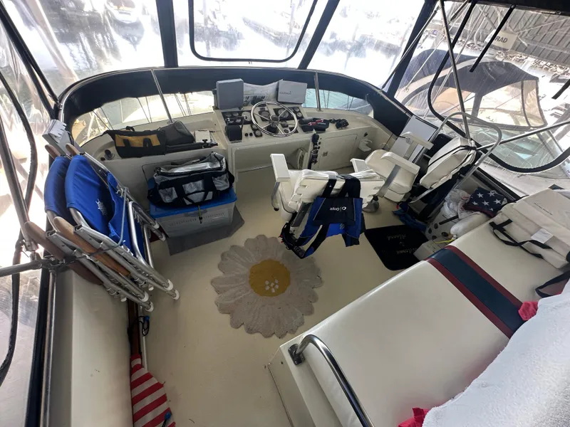 Slide: The Image of 1989 Tollycraft 30 Sedan boat interior with helm, seating, and nautical equipment. - 10