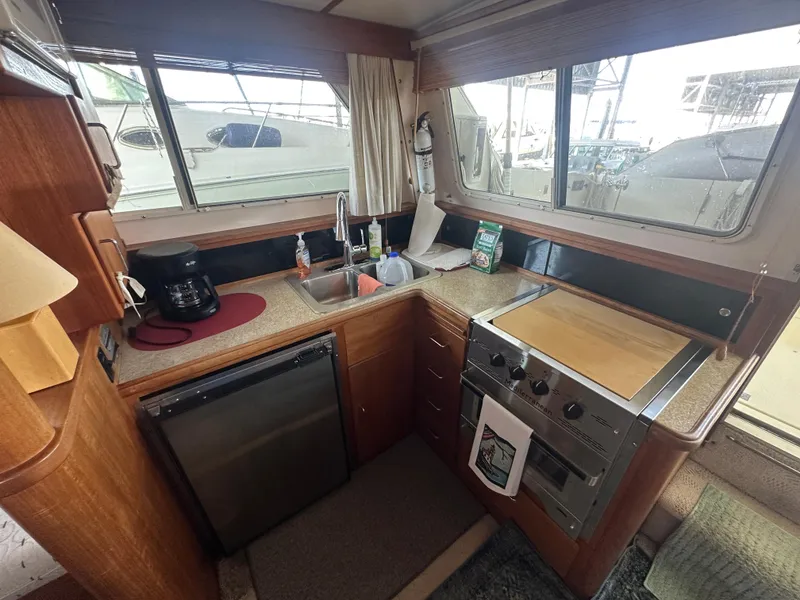 Slide: The Image of 1989 Tollycraft 30 Sedan yacht kitchen with stove, sink, and coffee maker. - 12