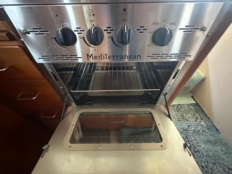 Slide: The Image of Oven in 1989 Tollycraft 30 Sedan boat kitchen, featuring Mediterranean design. - 20