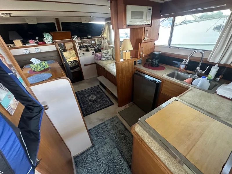Slide: The Image of Interior of 1989 Tollycraft 30 Sedan boat with kitchen and seating area. - 9