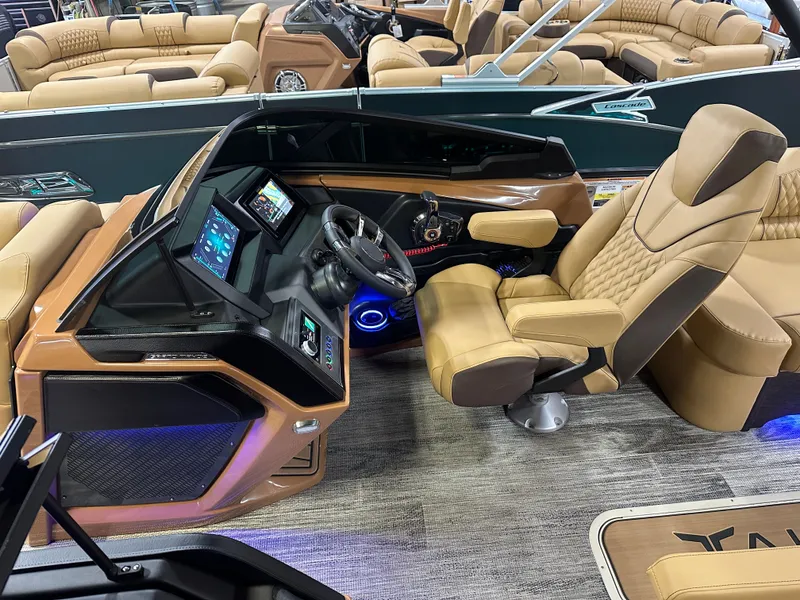 Slide: The Image of Luxurious 2025 Tahoe Grand Tahoe 2585 Tritoon helm with plush seating and advanced controls. - 13