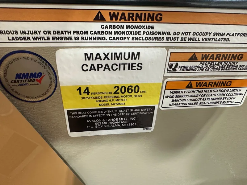 Slide: The Image of Warning labels on 2025 Tahoe Grand Tahoe 2585 Tritoon, indicating maximum capacity and safety precautions. - 23