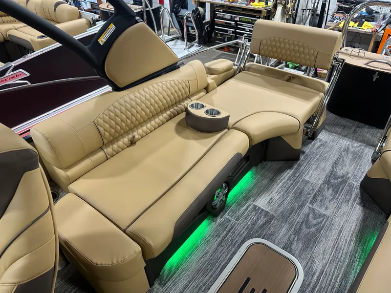 Slide: The Image of Luxurious seating in 2025 Tahoe Grand Tahoe 2585 Tritoon with ambient lighting and cup holders. - 24