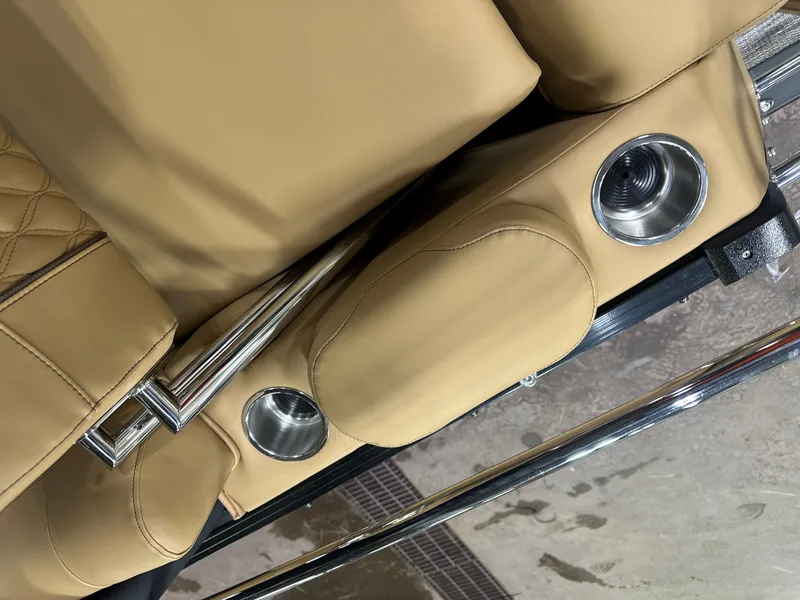 Slide: The Image of Luxurious tan seating with cup holders in 2025 Tahoe Grand Tahoe 2585 Tritoon. - 32