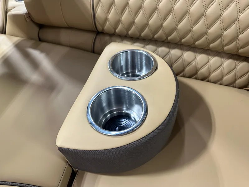 Slide: The Image of Luxurious beige leather seating with dual cup holders in 2025 Tahoe Grand Tahoe Tritoon. - 33