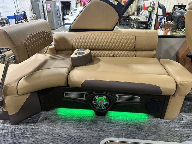 Slide: The Image of Luxurious seating in 2025 Tahoe Grand Tahoe 2585 Tritoon with ambient lighting and cup holders. - 34