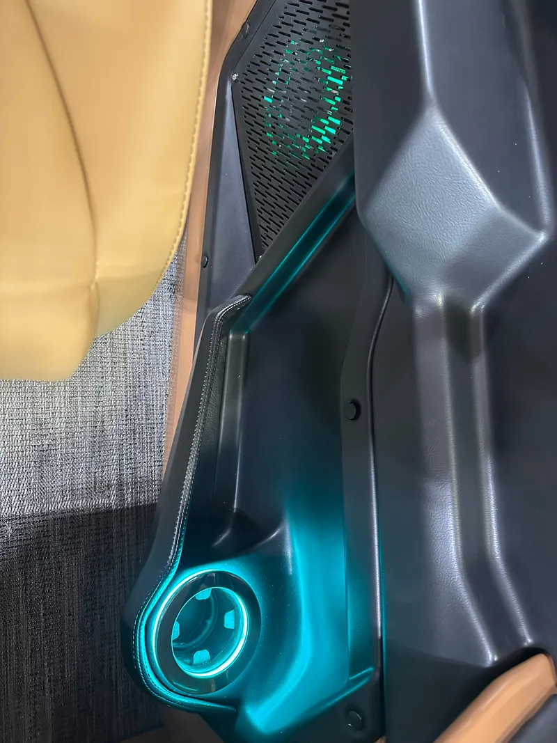 Slide: The Image of Interior detail of 2025 Tahoe Grand Tahoe 2585 Tritoon, featuring illuminated cup holder and speaker. - 37