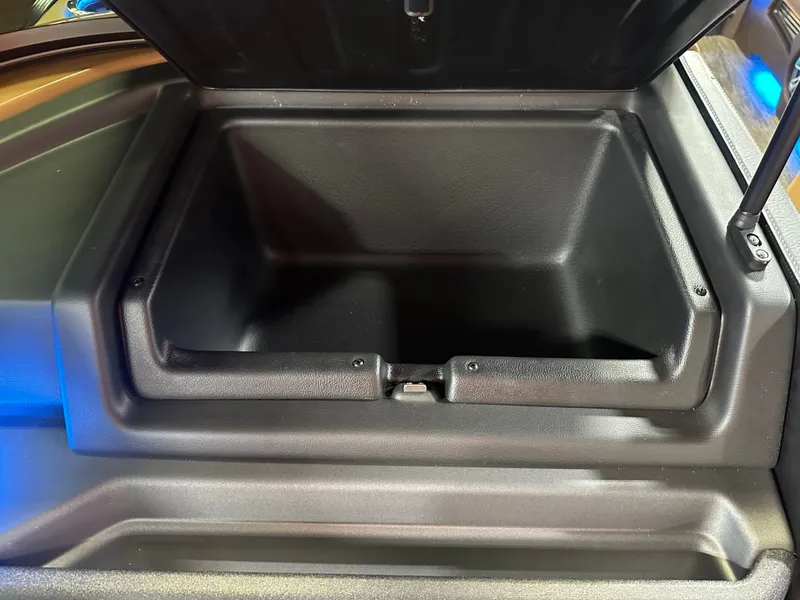 Slide: The Image of Open storage compartment in 2025 Tahoe Grand Tahoe 2585 Tritoon boat. - 38