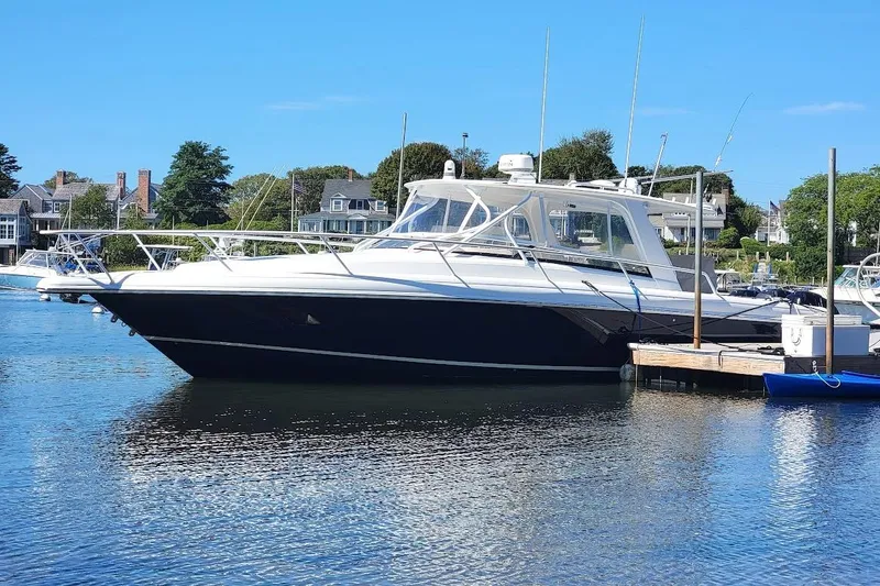 Slide: The Image of 2010 Intrepid 39 Kevlar Hull Sport Yacht docked in a scenic marina. - 0