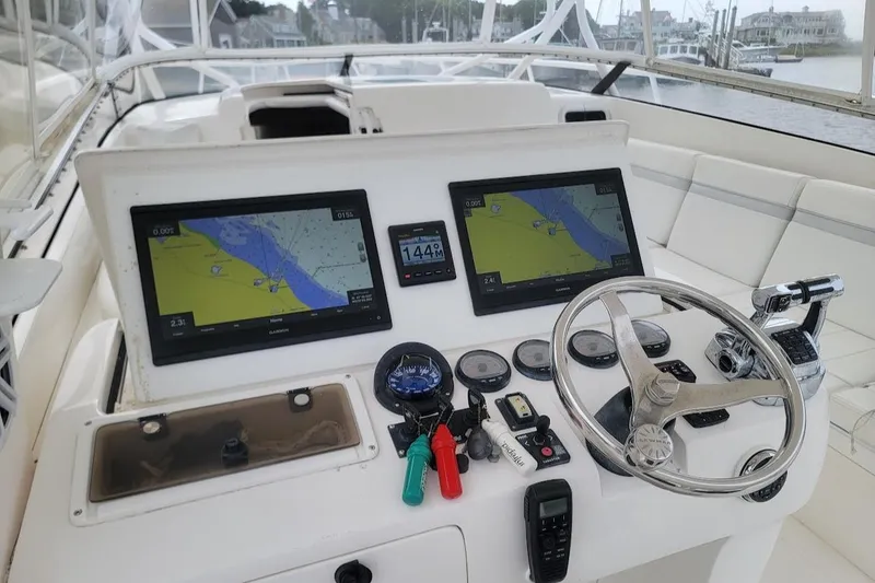 Slide: The Image of 2010 Intrepid 39 Kevlar Hull yacht cockpit with navigation screens and steering wheel. - 1