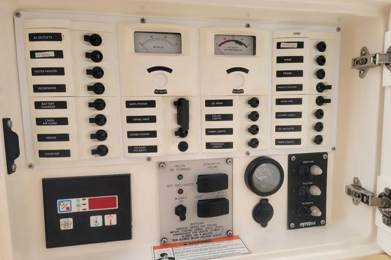 Slide: The Image of Control panel of a 2010 Intrepid 39 Kevlar Hull Sport Yacht, featuring various switches and gauges. - 11