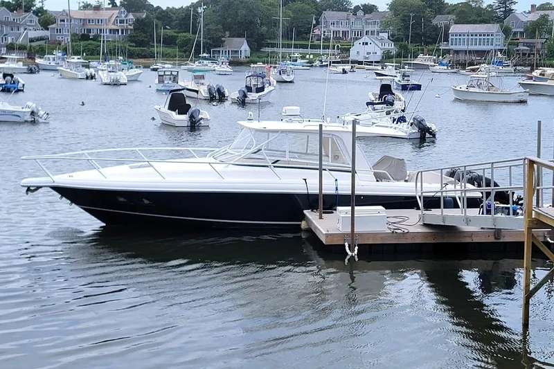 Slide: The Image of 2010 Intrepid 39 Kevlar Hull Sport Yacht docked in a scenic marina. - 17