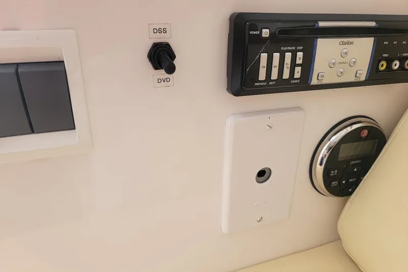 Slide: The Image of Control panel of a 2010 Intrepid 39 Kevlar Hull yacht with audio system and switches. - 22