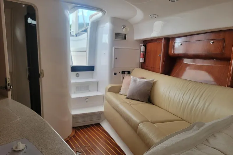 Slide: The Image of Interior of 2010 Intrepid 39 Kevlar Hull yacht with beige leather seating and wooden accents. - 23