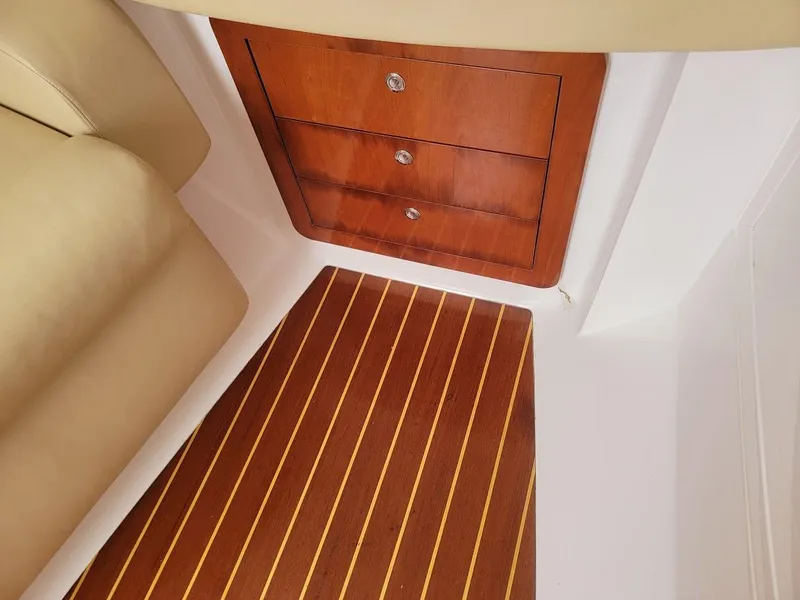 Slide: The Image of Interior of 2010 Intrepid 39 Kevlar Hull yacht with wooden drawers and striped flooring. - 25
