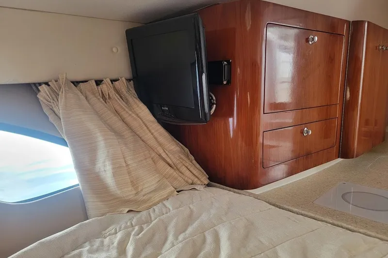 Slide: The Image of Interior of 2010 Intrepid 39 Kevlar Hull yacht with TV and wooden cabinetry. - 26