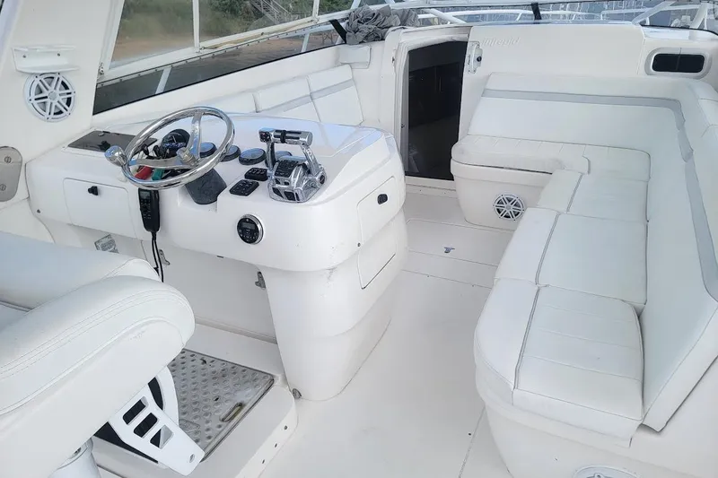 Slide: The Image of 2010 Intrepid 39 Kevlar Hull yacht interior with white seating and steering console. - 28