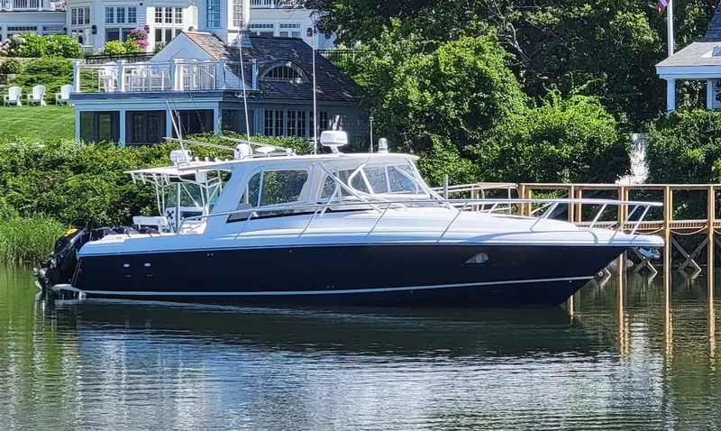 Slide: The Image of 2010 Intrepid 39 Kevlar Hull Sport Yacht docked by waterfront homes. - 3