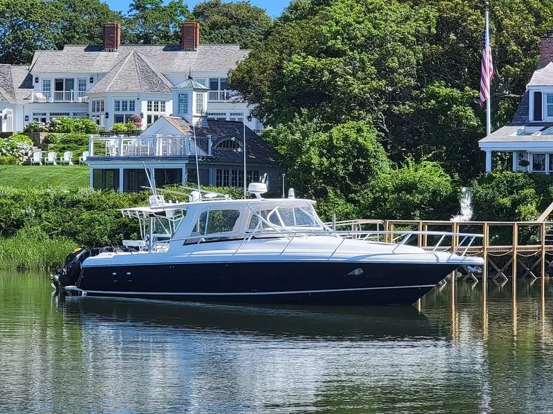 Slide: The Image of 2010 Intrepid 39 Kevlar Hull yacht docked by waterfront homes. - 30