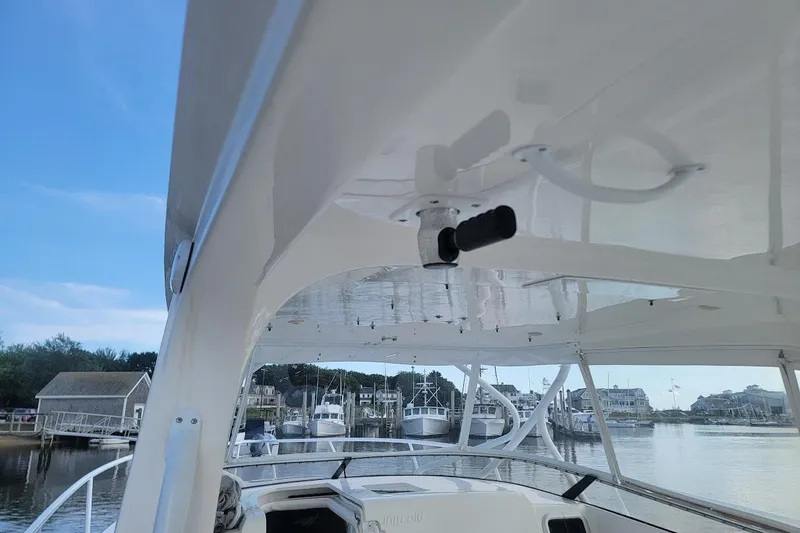 Slide: The Image of 2010 Intrepid 39 Kevlar Hull yacht docked at marina, showcasing sleek design and spacious deck. - 31