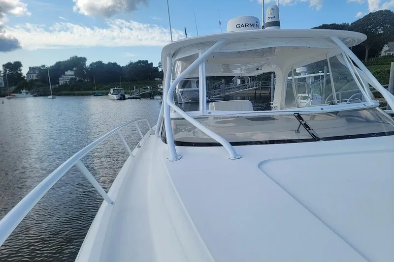 Slide: The Image of 2010 Intrepid 39 Kevlar Hull Sport Yacht docked on calm water. - 35