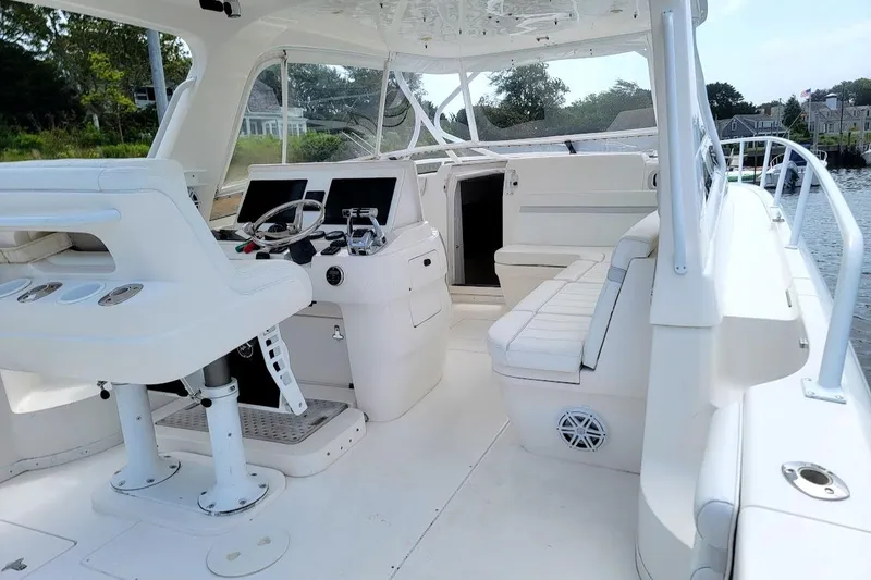 Slide: The Image of 2010 Intrepid 39 Kevlar Hull Sport Yacht interior with helm, seating, and water view. - 4