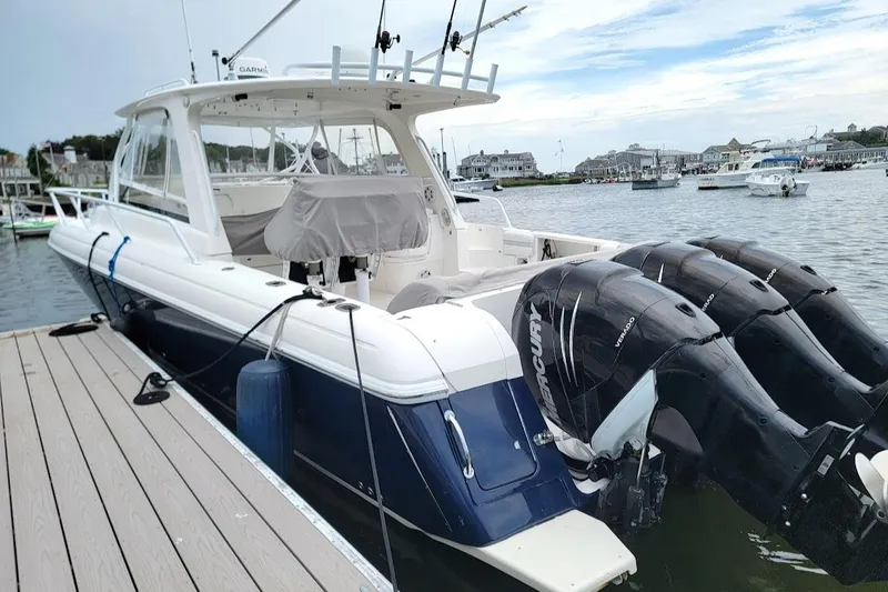 Slide: The Image of 2010 Intrepid 39 Kevlar Hull Sport Yacht docked, featuring powerful Mercury outboard engines. - 5