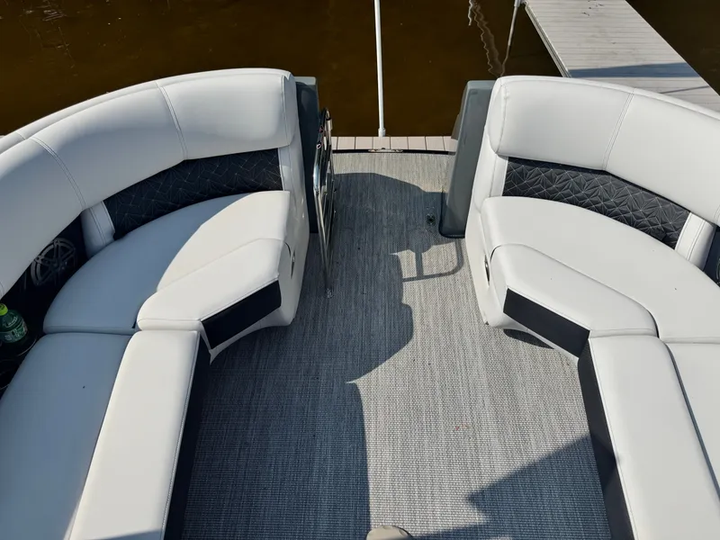 Slide: The Image of 2024 Harris 250 Grand Mariner boat interior with white seating and gray flooring. - 5